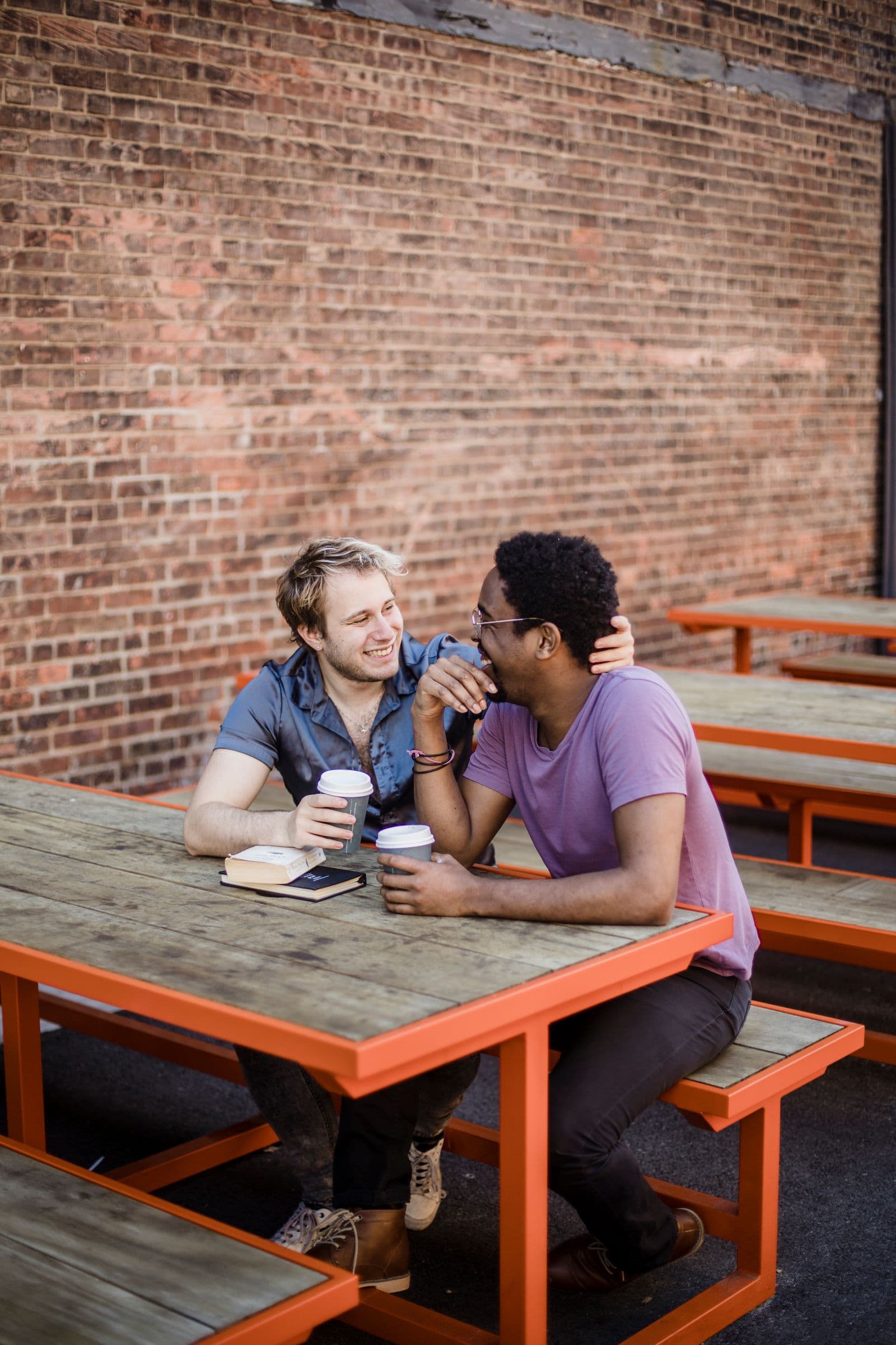 Two men sharing a relaxed moment at an outdoor café